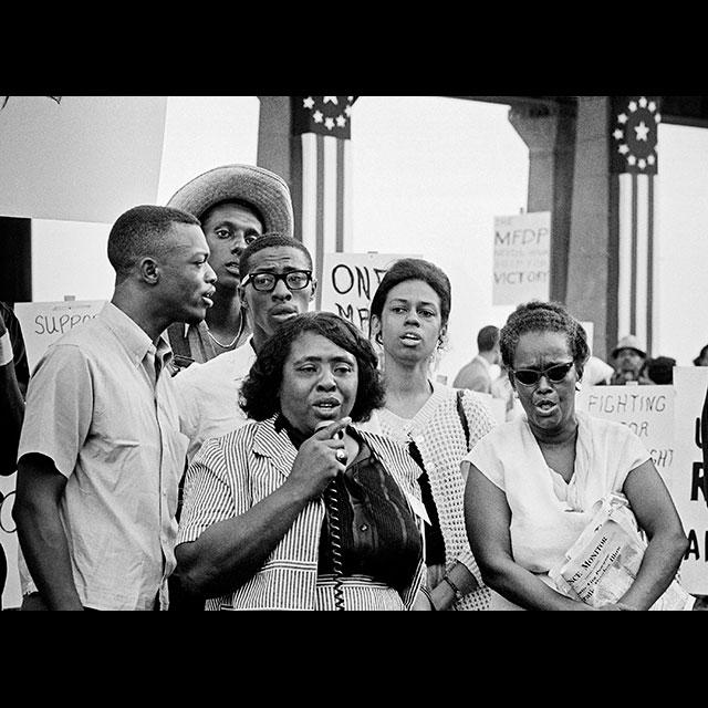 A black and white photograph of MFDP members rallying before the Democratic National Convention