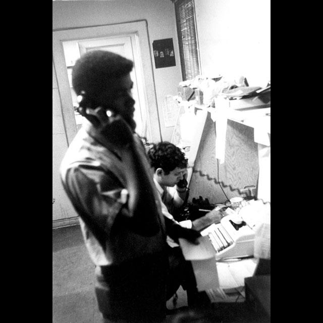 A black and white photograph of two volunteers working in a Freedom House